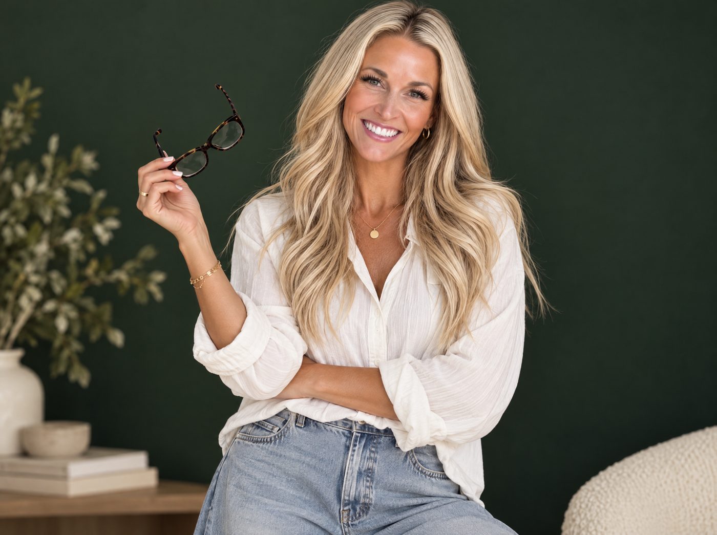 Ashley Wisroth smiling, holding her glasses